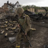 Ukrainian troops holding destroyed village believe Russians withdrawing across border