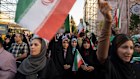 Protesters chant slogans and wave Iranian flags in Revolution Square, Tehran, to protest US attacks.