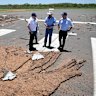 Prime Minister Anthony Albanese, Cloncurry Major Greg Campbell and Federal Treasurer Jim Chalmers at a damaged Cloncurry Airport on Tuesday.