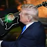 Donald Trump holds up replica of an Elvis Presley guitar after signing it.