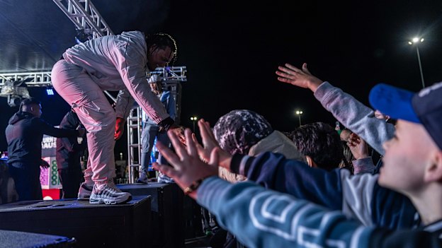 Spenny reaches out to fans as he performs at OneFour’s album launch event at Sydney Dragway in Eastern Creek, in Sydney’s west on Thursday night. 