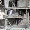 People work in the rubble of a building hit by a US-Israeli strike on a commercial district on March 29, 2026 in Tehran, Iran.