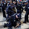 Police detain a protester during a protest against the visit of Israel’s President Isaac Herzog. 