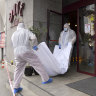 Forensic workers carry the body of Gholamreza Mansouri from a hotel in  Bucharest, Romania
