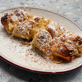 Custard-filled bougatsa dusted with icing sugar.