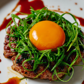 Duck hambagu with tare egg yolk and spring onion.