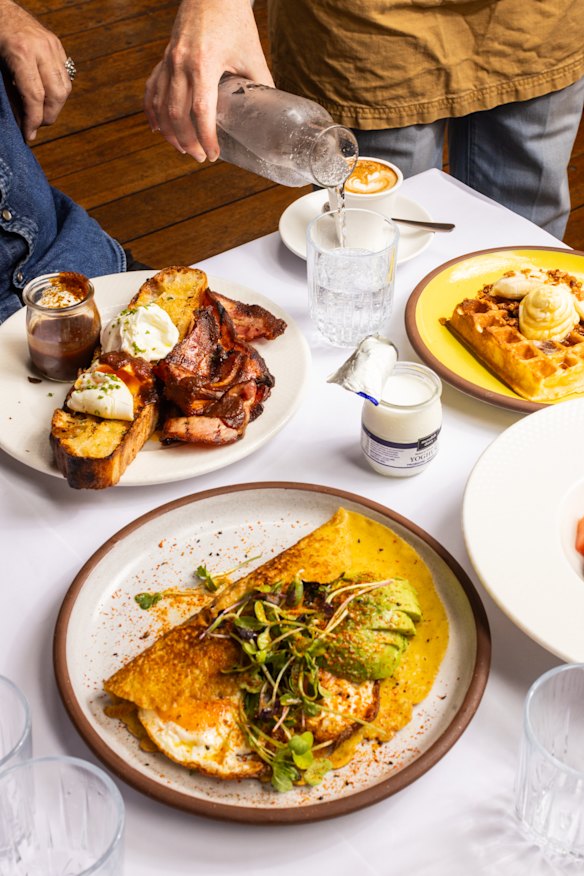 Chickpea pancake with fried eggs and herb salad.