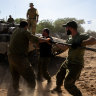 Israeli soldiers clean the barrel of a tank in southern Israel.