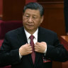 Chinese President Xi Jinping adjusts his jacket during the closing session of the National People’s Congress held at the Great Hall of the People in Beijing on Monday.