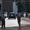 Omani security personnel watch a convoy believed to be carrying US envoy Steve Witkoff in Muscat, Oman, on Saturday.