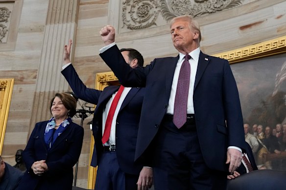 President Donald Trump (centre) gestures as he is joined on stage by Vice President J.D. Vance after being sworn in.