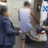 A teenager is arrested in a counter-terrorism raid in Sydney last month.