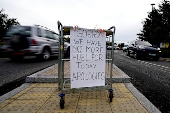 A sign referring to the lack of fuel is placed at the entrance to a petrol station in London on Tuesday.