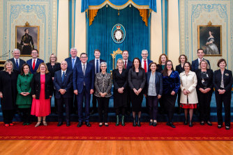 Government members pose for a group photo at Government House during the swearing-in ceremony on Monday.