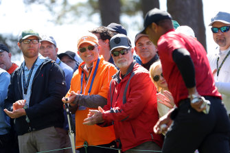 Tiger Woods is warmly applauded as he walks off the third green at The Masters.