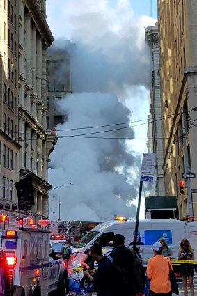 Steam billows between buildings after a steam pipe exploded under Fifth Avenue in Manhattan.