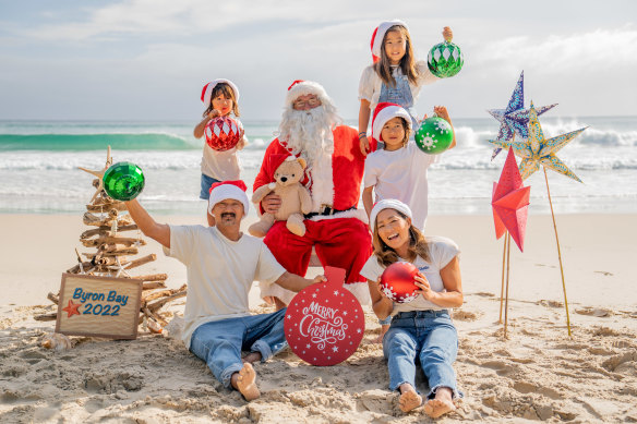 The Konno family with Santa on the beach in Byron Bay for their 2022 Christmas photo.