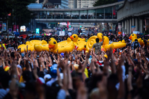 Protesters carry inflatable ducks at the Ratchaprasong Intersection in Bangkok, Thailand, on Thursday.