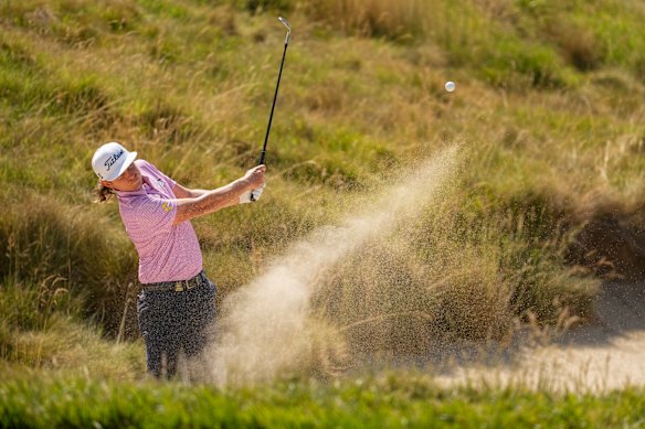 Cameron Smith hits from the bunker on the eighth hole.