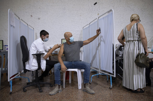 An Israeli takes a selfie while receiving his Pfizer booster in Ramat Gan, Israel, Monday, August 30, 2021.
