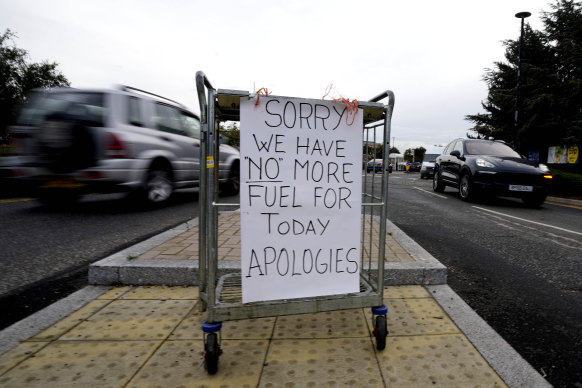 A sign referring to the lack of fuel is placed at the entrance to a petrol station in London on Tuesday.