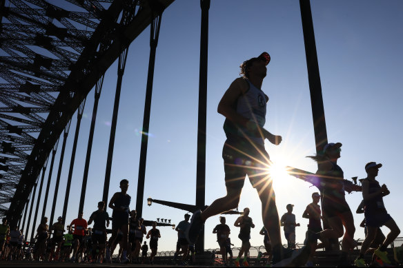 Competitors run across the Sydney Harbour Bridge.