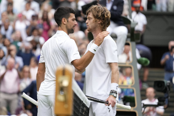 Novak Djokovic and Andrey Rublev embrace after their Wimbledon quarter-final.
