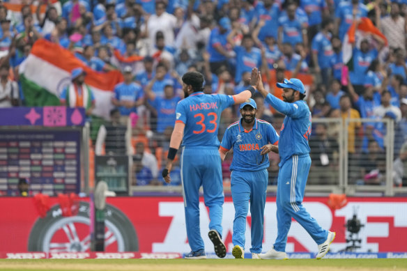 India’s Hardik Pandya is congratulated by captain Rohit Sharma after taking the wicket of Pakistan’s Mohammad Nawaz.