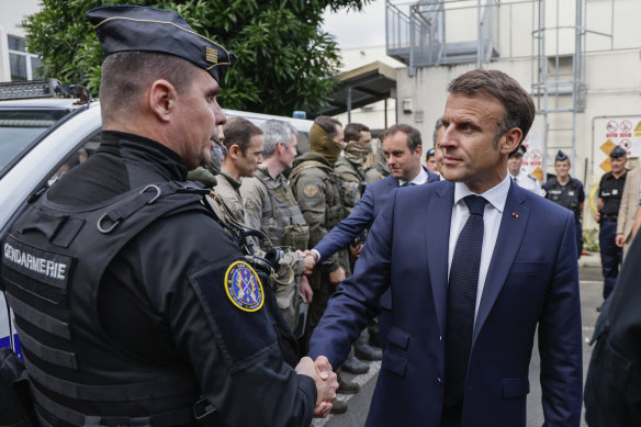 French President Emmanuel Macron visits the central police station in Noumea, New Caledonia.