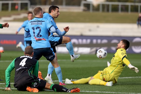 Western United goalkeeper Ryan Scott denies Kosta Barbarouses.
