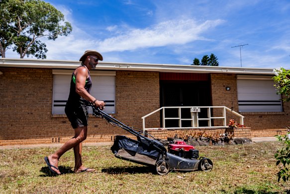 Property maintenance worker George Tsoukalidis mowing a client’s lawn in Greystanes, Sydney, on a hot day this week.