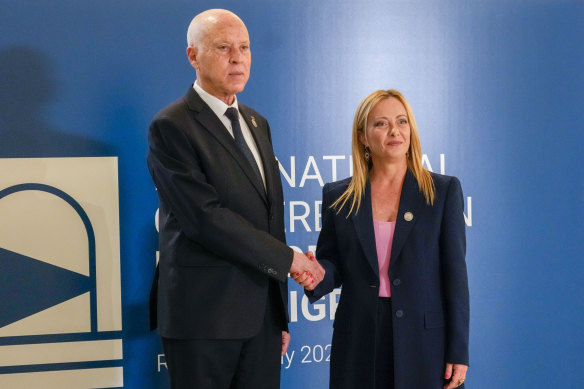Italian Premier Giorgia Meloni, right, welcomes Tunisian President Kaïs Saïed as he arrives to attend an International conference on migration in Rome.
