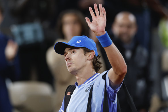 Alex de Minaur waves to the fans.