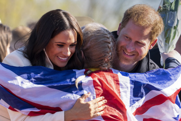Give us a hug: Prince Harry and Meghan demonstrate how it’s done, hugging Lisa Johnston, a former army medic and amputee, who celebrates with her medal at the Invictus Games venue in The Hague, Netherlands, in April this year.