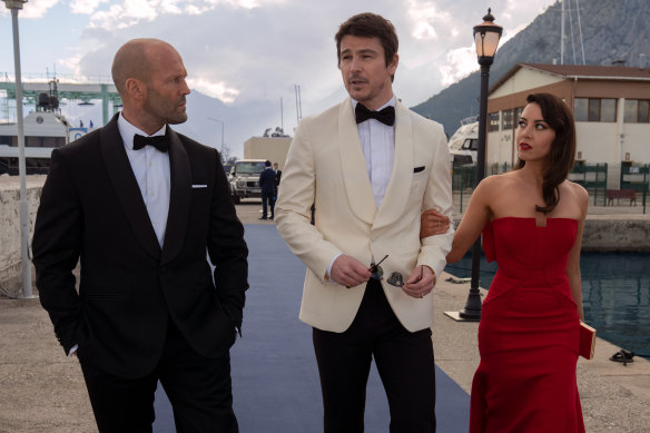 Spy Orson Fortune (Jason Statham) and his American associate Sarah Fidel (Aubrey Plaza, right) recruit a movie star (Josh Hartnett) in Operation Fortune: Ruse de Guerre.