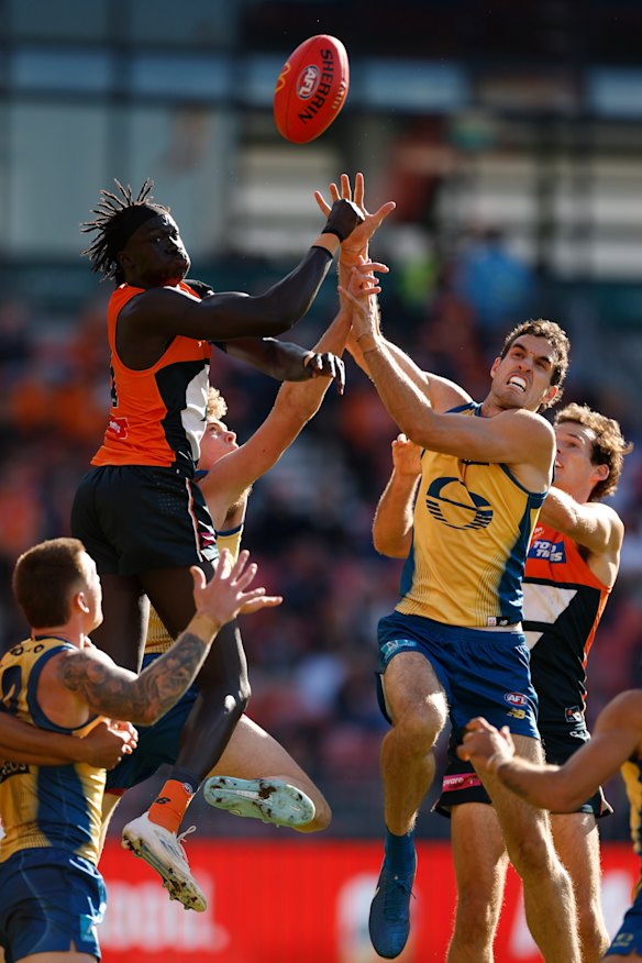 GWS defender Leek Aleer (left) flies against Gold Coast’s Ben King in a marking contest on Sunday.