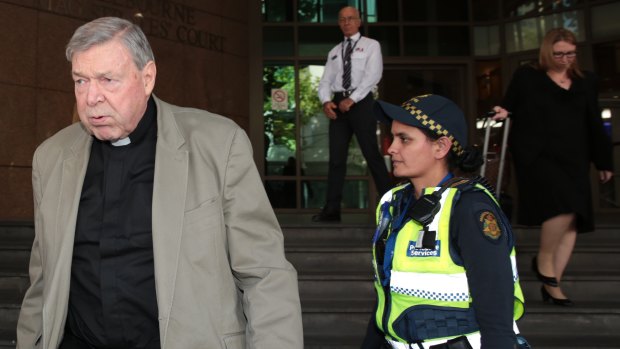 Cardinal Pell leaves court on Monday.