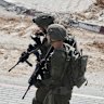 Israeli soldiers take up positions during an army operation in the West Bank city of Hebron.