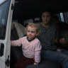 Maria and her family near the border crossing with Poland. They have been on the road for four days. 