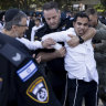 Ultra-Orthodox Jewish men clash with police officers during a protest against drafting into the Israeli army in Bnei Brak, Israel.