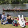 A rowing boat passes spectators on the river bank on the opening day of the 2019 Henley Royal Regatta alongside the river Thames. (Photo by Steve Parsons/PA Images via Getty Images) ...