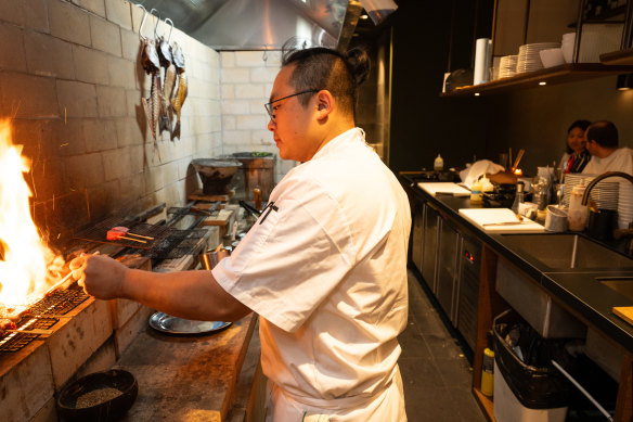 Co-owner Raymond Hou on the grill at Firepop.