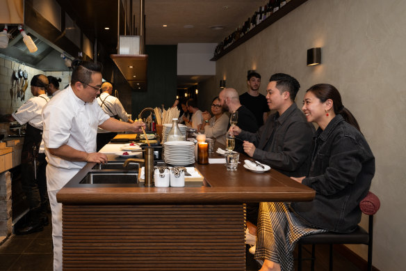 The 3.5-metre chef’s table faces a line-up of charcoal and wood grills.