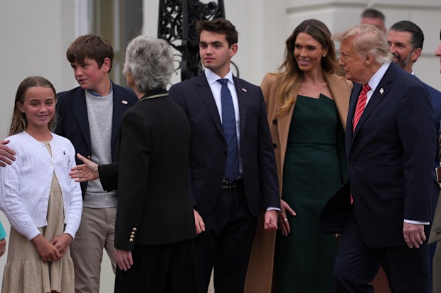 U.S. President Donald Trump’s family, Donald Trump Jr, rear right, and wife Bettina, third right, and their children are welcomed by Ireland’s President Catherine Connolly at Aras an Uachtarain in Dublin