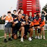 Kieren Briggs and Josaia Delana of the Giants pose for a photo with students during the Western Sydney 2025 AFL