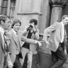October 1981: Christopher Dale Flannery (second from left) is led handcuffed into Melbourne's City Watch House to be charged with the murder of Roger Wilson.