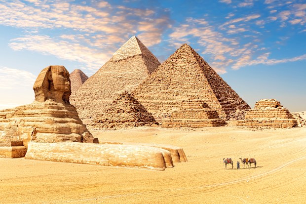 The Great Sphinx next to the Pyramids of Egypt in the desert of Giza