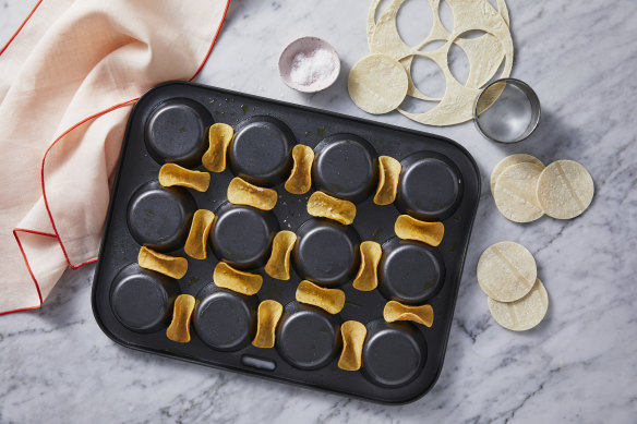 Use an upside-down muffin tray to shape the mini taco shells.