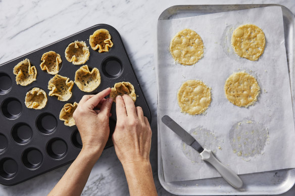 Quickly transfer the cheese discs into muffin holes, reshape into baskets, then re-bake.