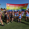 SYDNEY, AUSTRALIA - JANUARY 28: Players run through a joint banner during the 2022 AFLW Round 04 match between the GWS Giants and the Western Bulldogs at Henson Park on January 28, 2022 in Sydney, Australia. (Photo by Dylan Burns/AFL Photos via Getty Images)
